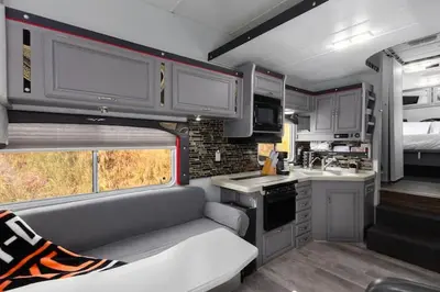 a kitchen in an rv with a couch in it at Harley Davidson Ranch Glampling With Kids Play Zone in Ramona