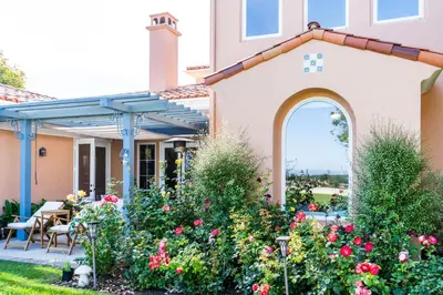 a house with a garden with flowers at Escape to Luxury Newport Coast Pelican Gated Home in Newport Beach