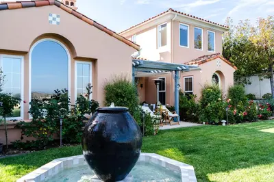 a large black vase in the yard of a house at Escape to Luxury Newport Coast Pelican Gated Home in Newport Beach
