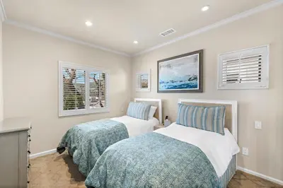 two beds in a room with two windows at Laguna Villa in Laguna Beach