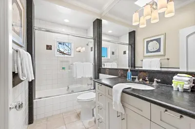 a bathroom with a sink and a toilet and a tub at Laguna Villa in Laguna Beach