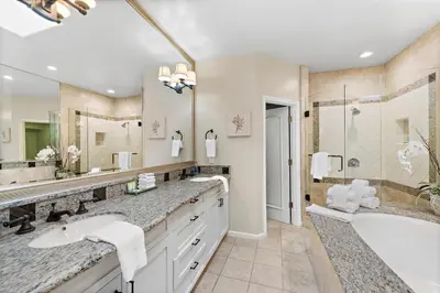 a bathroom with two sinks and a tub and a shower at Laguna Villa in Laguna Beach