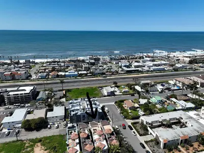 an aerial view of a city next to the ocean at Tuscany on Tremont in Oceanside