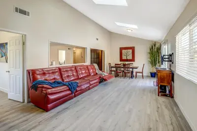 a red leather couch in a living room at Sunny Vista Vacation Rental Home 12 Mi to Beach! in Vista