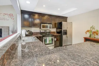 a kitchen with a sink and a refrigerator at Sunny Vista Vacation Rental Home 12 Mi to Beach! in Vista