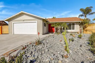 a house with a white garage and a driveway at Sunny Vista Vacation Rental Home 12 Mi to Beach! in Vista