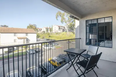 a balcony with a table and chairs and a view of a parking lot at La Jolla 1br w gym wd pool nr bars shops SAN-7 in San Diego