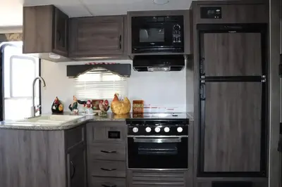 a kitchen with a stove and a microwave at RV quiet place in the mountain in Hemet