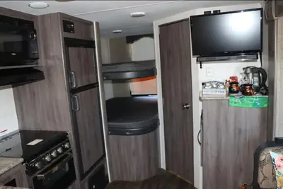 a small room with a door and a television in an rv at RV quiet place in the mountain in Hemet
