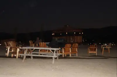 a group of chairs and a table and a gazebo at night at RV quiet place in the mountain in Hemet