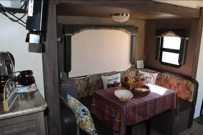 a living room with a table and a couch at RV quiet place in the mountain in Hemet