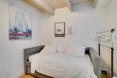 a bedroom with a bed with white sheets and pillows at Newport Beach Vacation Rental Near Beach and Pier in Newport Beach