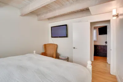 a bedroom with a bed and a tv on the wall at Newport Beach Vacation Rental Near Beach and Pier in Newport Beach