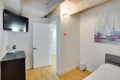 a bedroom with a bed and a tv on a wall at Newport Beach Vacation Rental Near Beach and Pier in Newport Beach
