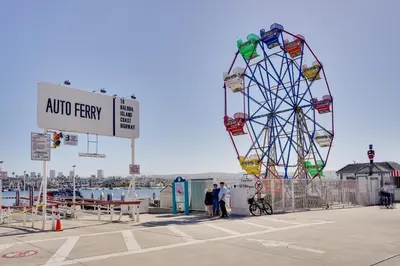 a ferris wheel with people standing in front of it at Newport Beach Vacation Rental Near Beach and Pier in Newport Beach