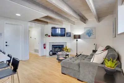a living room with a couch and a fireplace at Newport Beach Vacation Rental Near Beach and Pier in Newport Beach