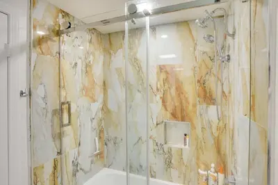 a bathroom with a shower with a glass door at Newport Beach Vacation Rental Near Beach and Pier in Newport Beach