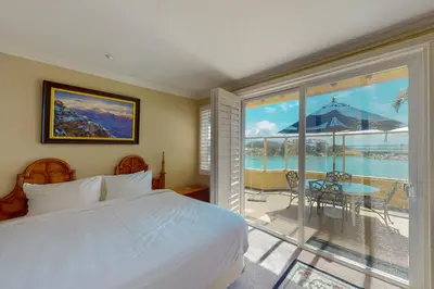 a bedroom with a bed and a balcony with a view at Lagoon Sunrise 205 - 30-Night Minimum in Carlsbad