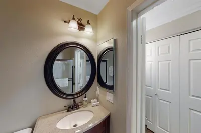 a bathroom with a sink and two mirrors at Lagoon Sunrise 205 - 30-Night Minimum in Carlsbad