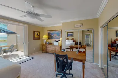 a bedroom with a bed and a desk and a bed at Lagoon Sunrise 205 - 30-Night Minimum in Carlsbad
