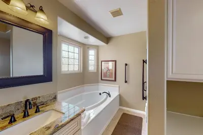 a bathroom with a tub and a sink at Lagoon Sunrise 205 - 30-Night Minimum in Carlsbad