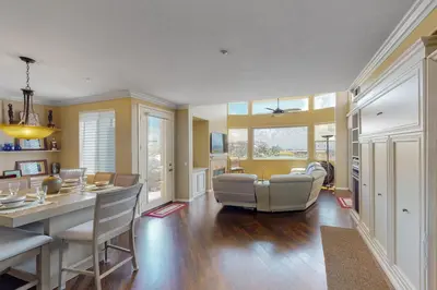a dining room and living room with a table and chairs at Lagoon Sunrise 205 - 30-Night Minimum in Carlsbad
