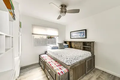 a bedroom with a bed and a ceiling fan at San Diego Home with Deck Walk to Mission Beach! in San Diego