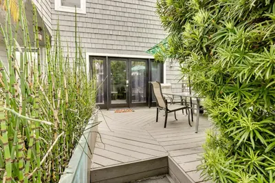a patio with a table and chairs and plants at San Diego Home with Deck Walk to Mission Beach! in San Diego