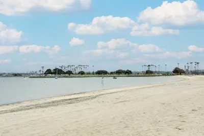 a sandy beach with boats in the water at San Diego Home with Deck Walk to Mission Beach! in San Diego