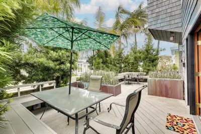 a patio with a table and chairs and an umbrella at San Diego Home with Deck Walk to Mission Beach! in San Diego
