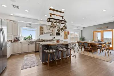 a kitchen and dining room with a table and chairs at Mountaintop Ramona Home Private Pool, Near Lake! in Ramona