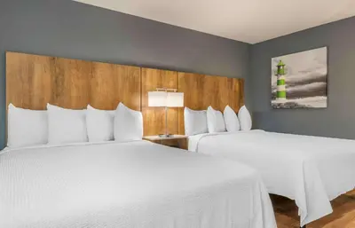 two beds in a hotel room with white sheets at Extended Stay America Premier Suites - San Diego - San Marcos in San Marcos
