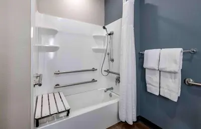 a bathroom with a tub and a shower with towels at Extended Stay America Premier Suites - San Diego - San Marcos in San Marcos