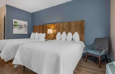 a hotel room with a large bed and a chair at Extended Stay America Premier Suites - San Diego - San Marcos in San Marcos